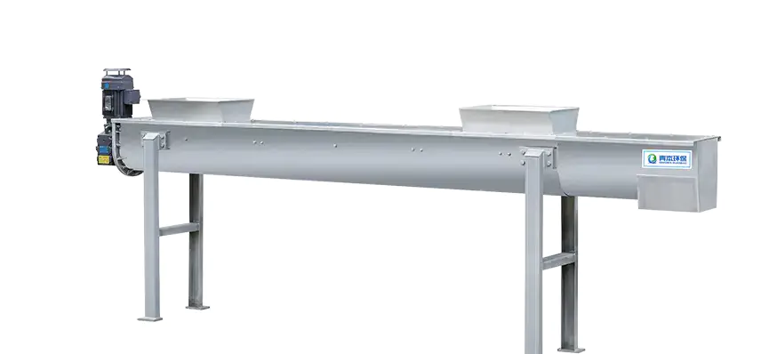 What role does the screw conveyor play in sludge treatment?